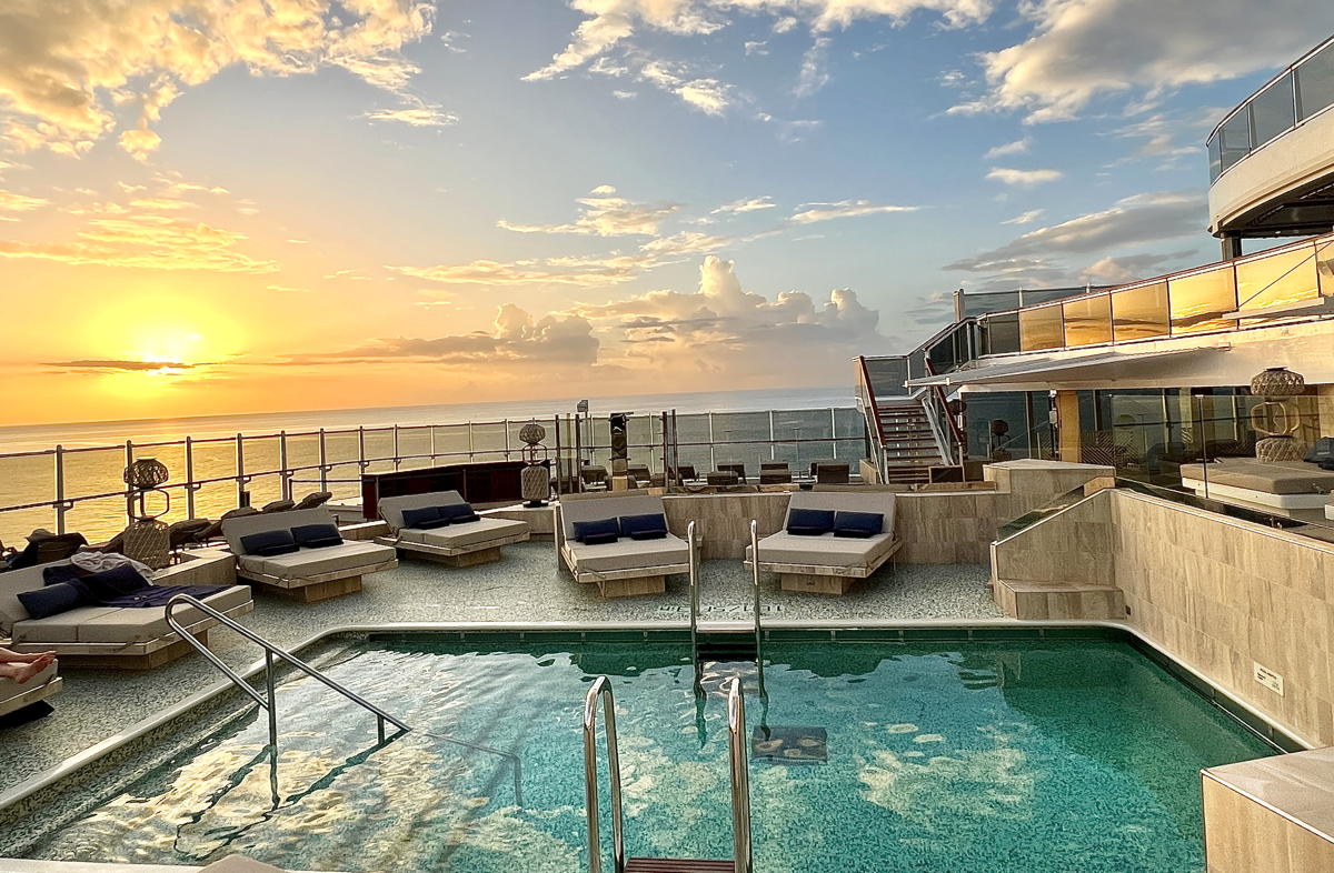 Sunset by a pool on board EXPLORA I. (Pax Global Media)