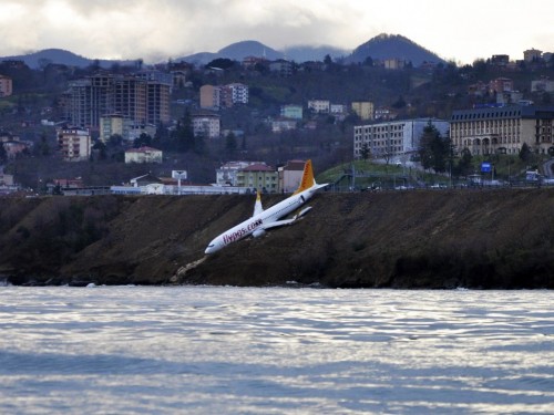 Plane slips off Turkey runway, hangs over Black Sea